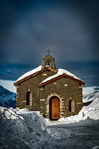 brown concrete chapel on snow coated mountain thumbnail