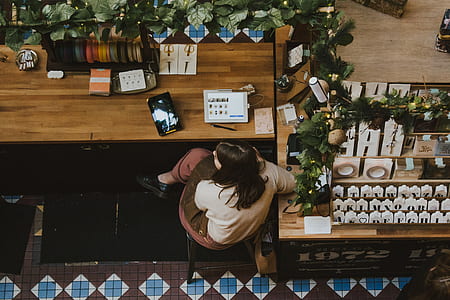 woman sitting on brown table thumbnail