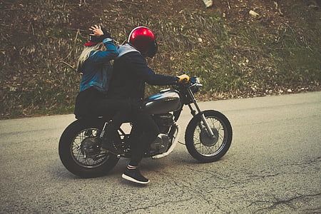 man and woman riding motorcycle on concrete road thumbnail