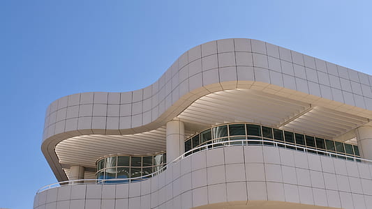 gray concrete building under blue sky thumbnail