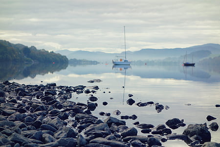 boat on river under white sky thumbnail