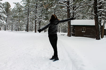 woman standing near house during winter season thumbnail