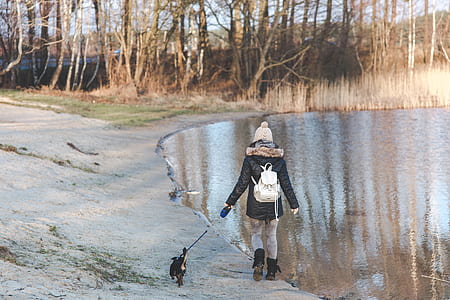 person near body of water wearing black fur parka jacket thumbnail