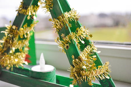 Shallow Focus Photography of Green and Yellow Candle Holder With White Candle thumbnail