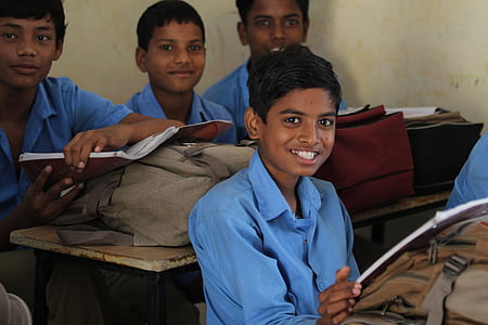 four boys in blue dress shirts posing for a photo thumbnail