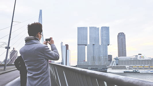 Rear View of Man Photographing Cityscape thumbnail