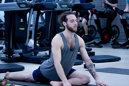 man in yoga pose inside gym thumbnail
