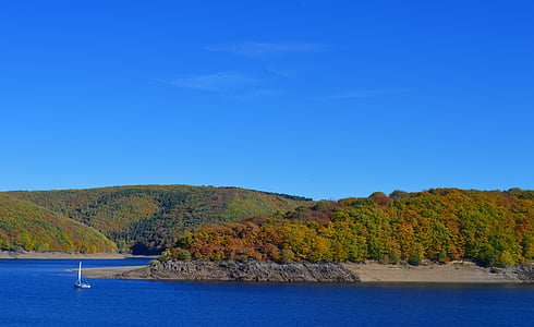 panoramic photo of island under blue sky thumbnail