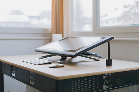 black monitor near Apple Magic keyboard and Magic mouse on desk inside room thumbnail