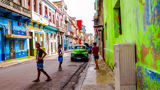 people walking on street between two painted buildings thumbnail