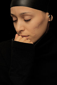 woman wearing black earphone while touching her lips thumbnail