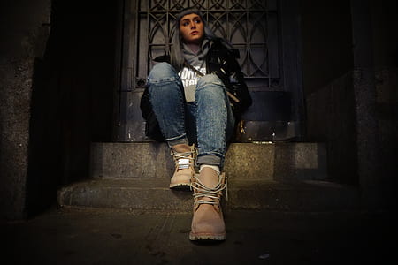 woman sitting on brown concrete stairs thumbnail