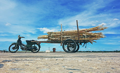 worm view photography of underbone motorcycle parked under cloudy sky thumbnail