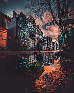 man riding on bicycle outside building thumbnail