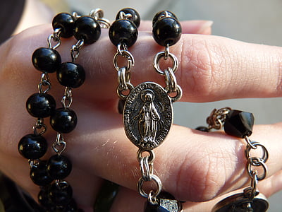 person holding rosary thumbnail