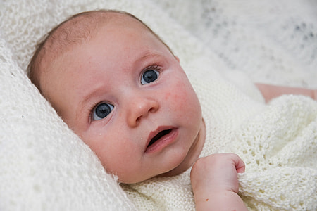 baby wearing white knitted scoop-neck top photo thumbnail