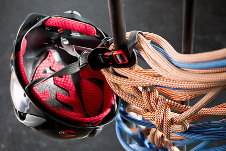 close-up photography of brown and blue ropes and balck and red helmet thumbnail