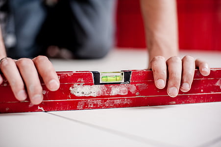 red wooden spirit lever holding by person thumbnail