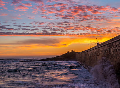 ocean waves slamming on concrete dock during golden hour thumbnail