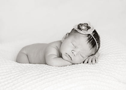baby sleeping on white mattress thumbnail