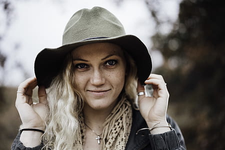 woman holding his gray cowboy hat thumbnail