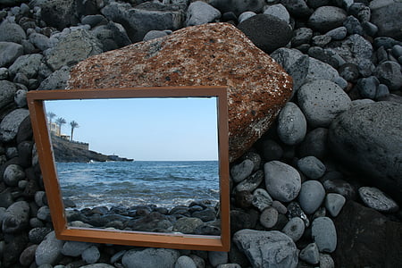 square brown wooden framed mirror on grey pebbles thumbnail