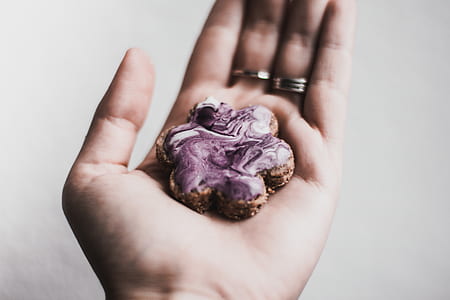person holding flower shaped cookie thumbnail