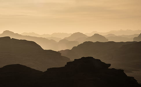 silhouette of mountains under cloudy sky thumbnail