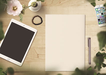 white iPad beside white printer paper thumbnail