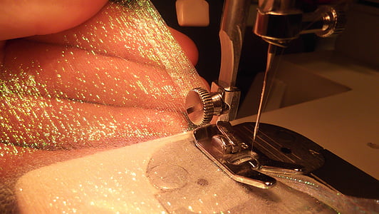 person holding clear wrap towards sewing machine thumbnail