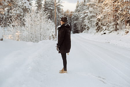 woman standing on snowy pathway thumbnail