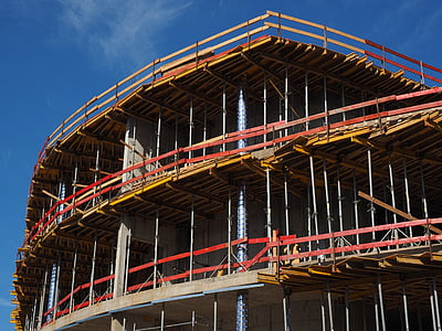 red and brown building frame at daytime thumbnail