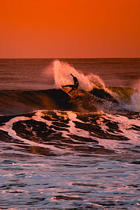 person surfing during sunset thumbnail