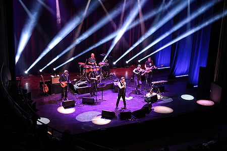 group of men performing on stage thumbnail