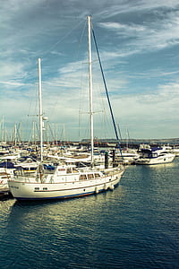 white boat beside beach dock thumbnail