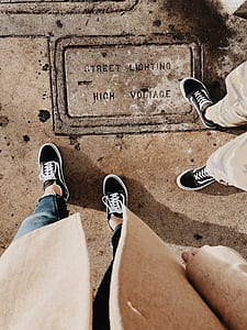 people wearing pair of black-and-white Vans low-top sneakers thumbnail