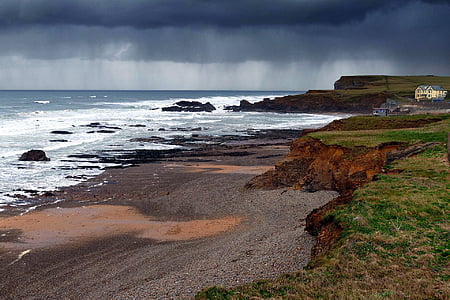 photography of mountain cliff beside seashore during daytime thumbnail