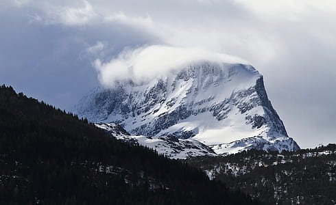 snow covered mountain covered in mist thumbnail