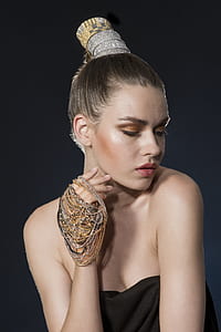 woman wearing black dress with jewelry on her hands thumbnail