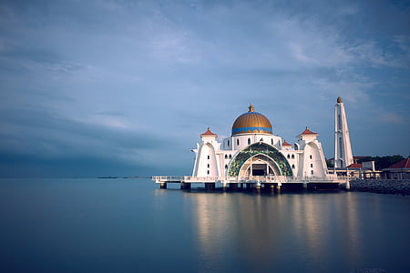 white and brown dome building near body of water during daytime thumbnail