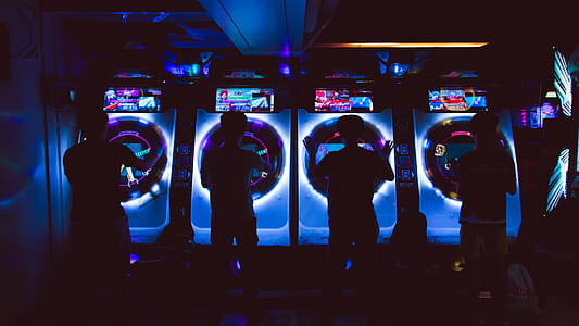 silhouette of four persons playing arcade thumbnail