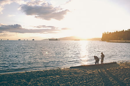 two men standing on seashore thumbnail