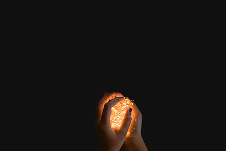 person holding string lights thumbnail