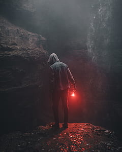 person holding light looking below thumbnail