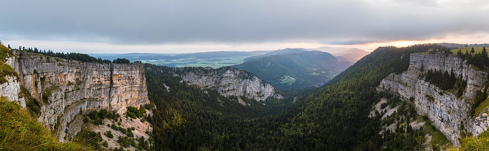 panoramic photo of mountains under cloudy sky thumbnail