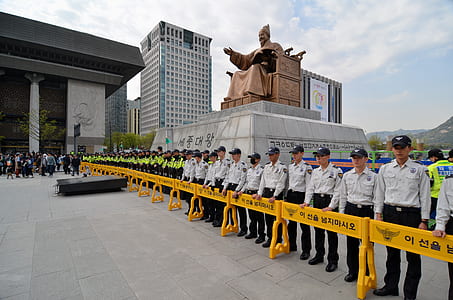 security standing beside statue during daytime thumbnail
