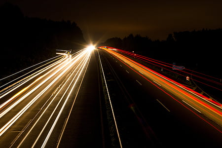 time-lapse photography of vehicle passing on road at night thumbnail