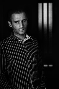 grayscale photo of man in striped dress shirt thumbnail