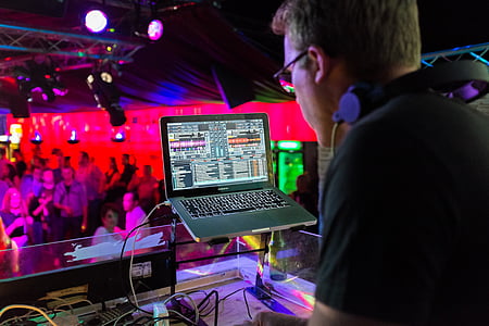 DJ playing music using laptop computer at the club thumbnail
