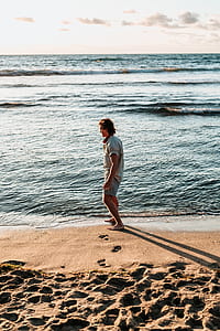 man standing beside shore thumbnail